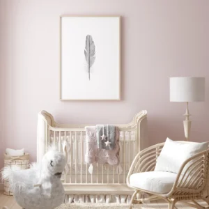 Stylish nursery with crib, chair, and feather art.