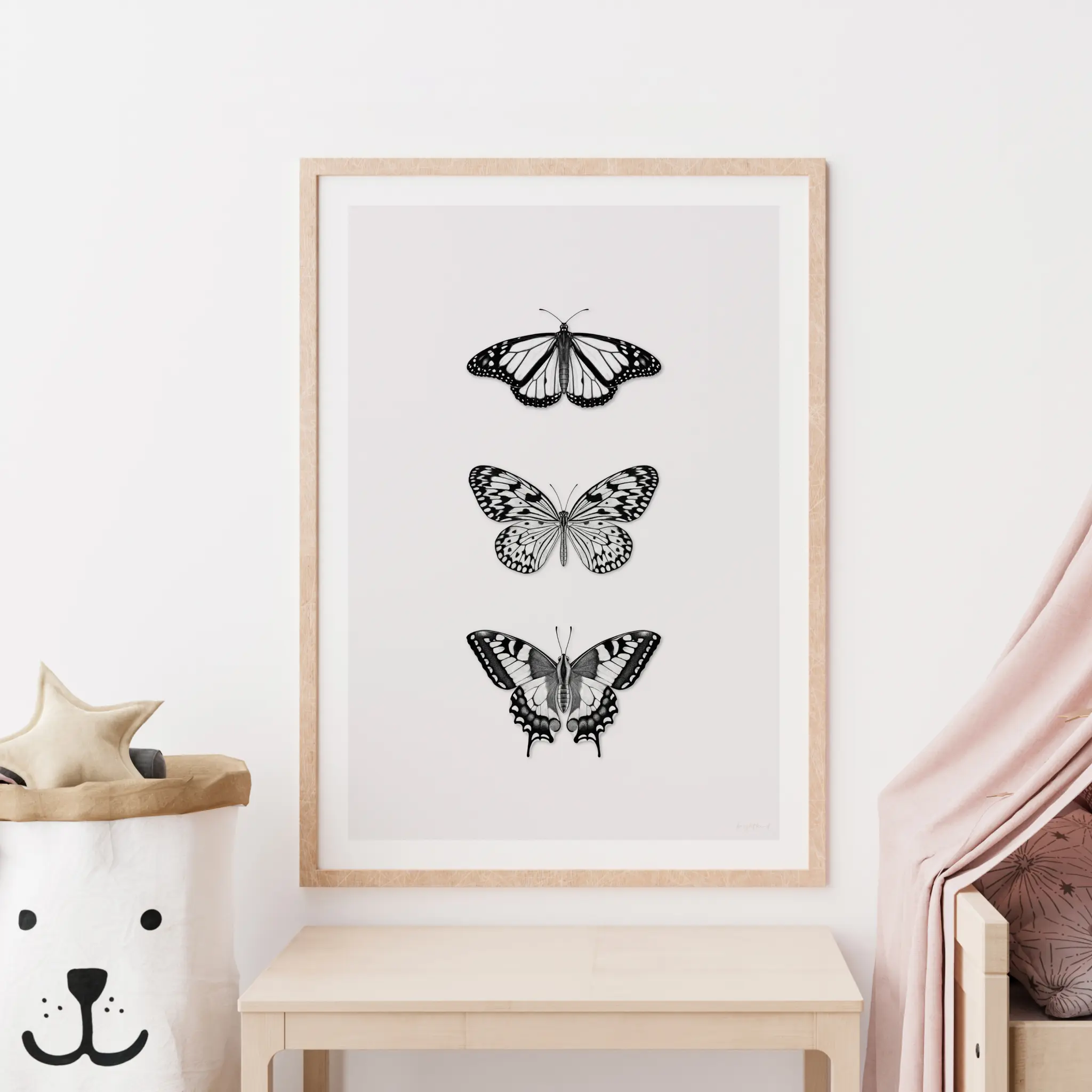 Framed black and white butterfly illustrations on wall.