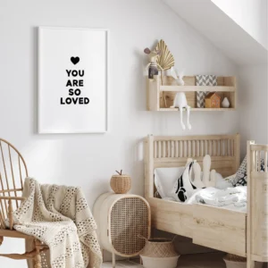 Cozy nursery decor with motivational "You Are So Loved" sign.